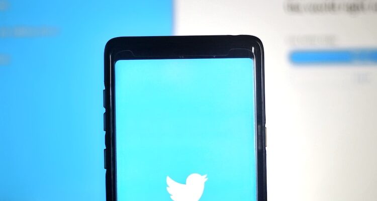 black smartphone on blue surface